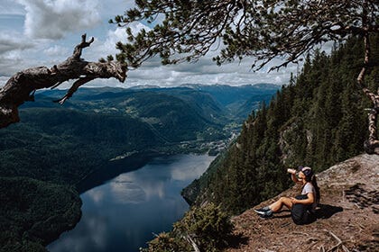 hiker in the forest with a view over a valley