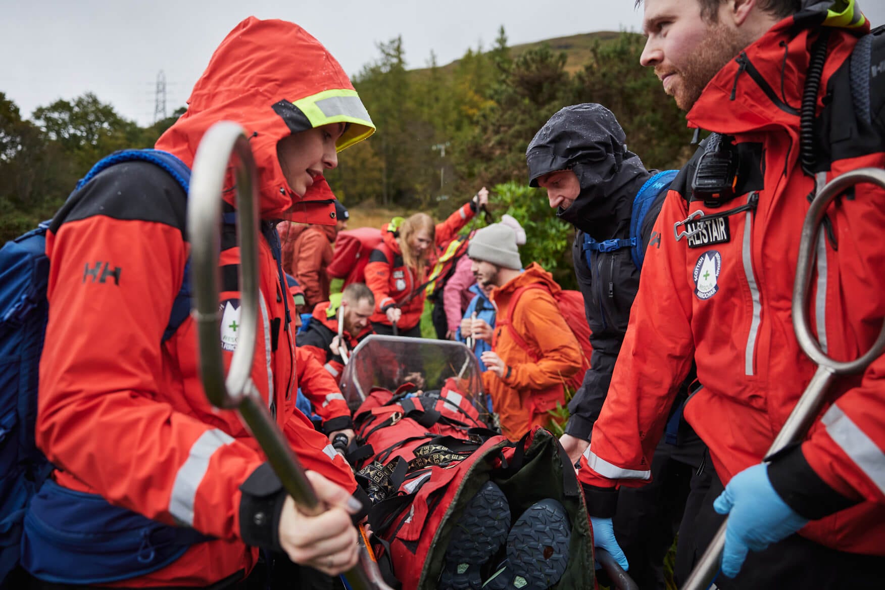 People carrying a stretcher in the outdoors
