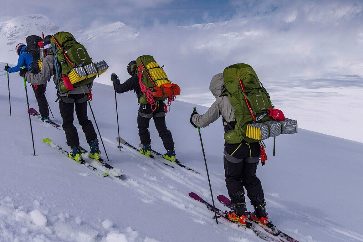 four people ski touring
