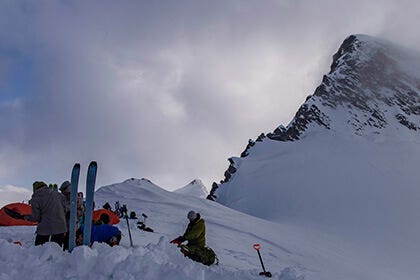People camping in the snow high on a mountain
