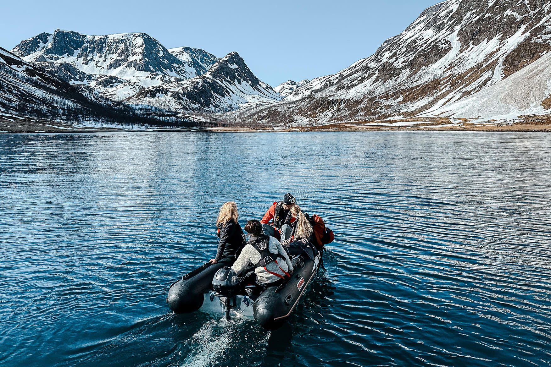 dinghy with four people in a fjord in Finnmark