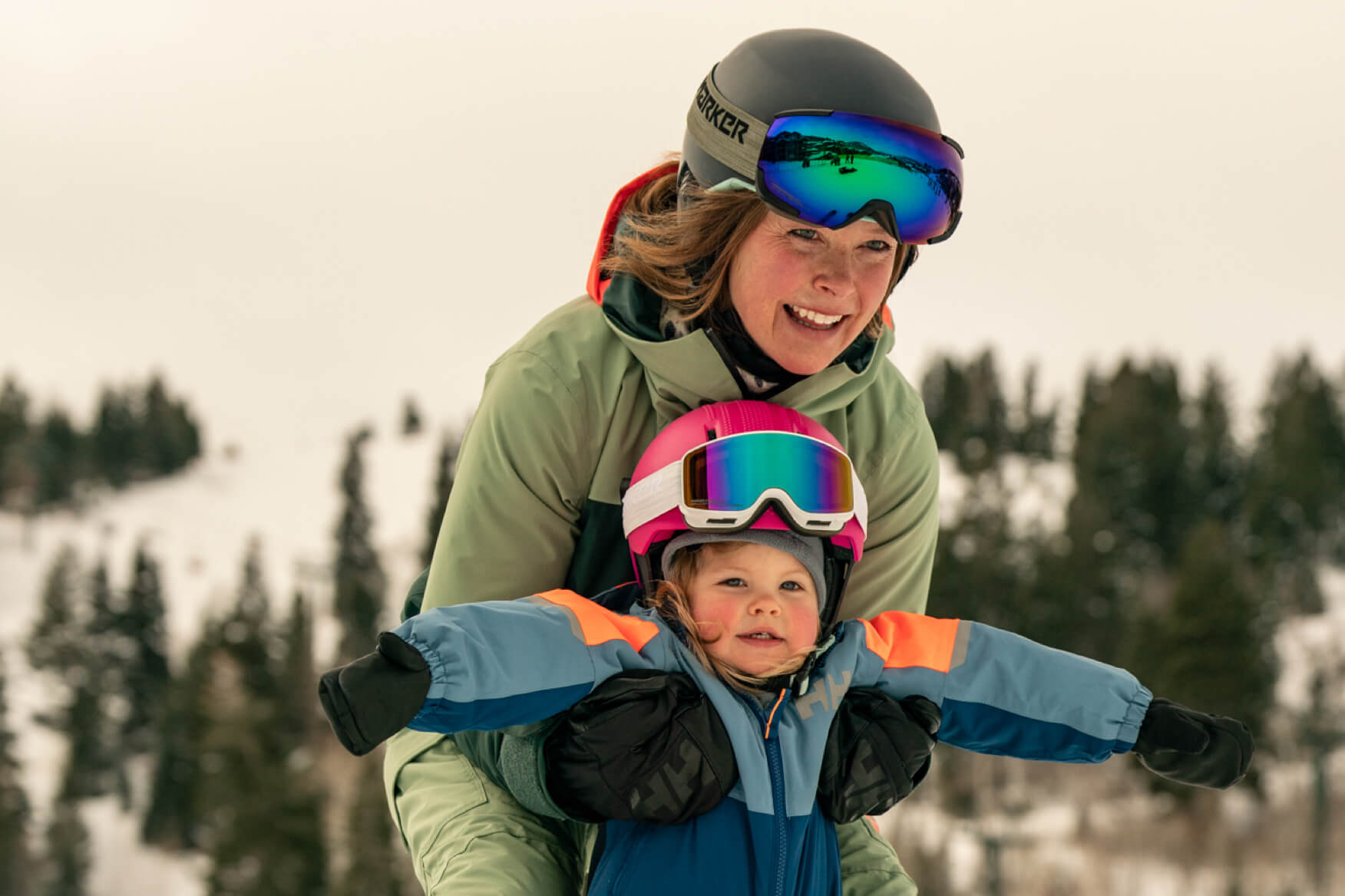 woman skiing with her young child 
