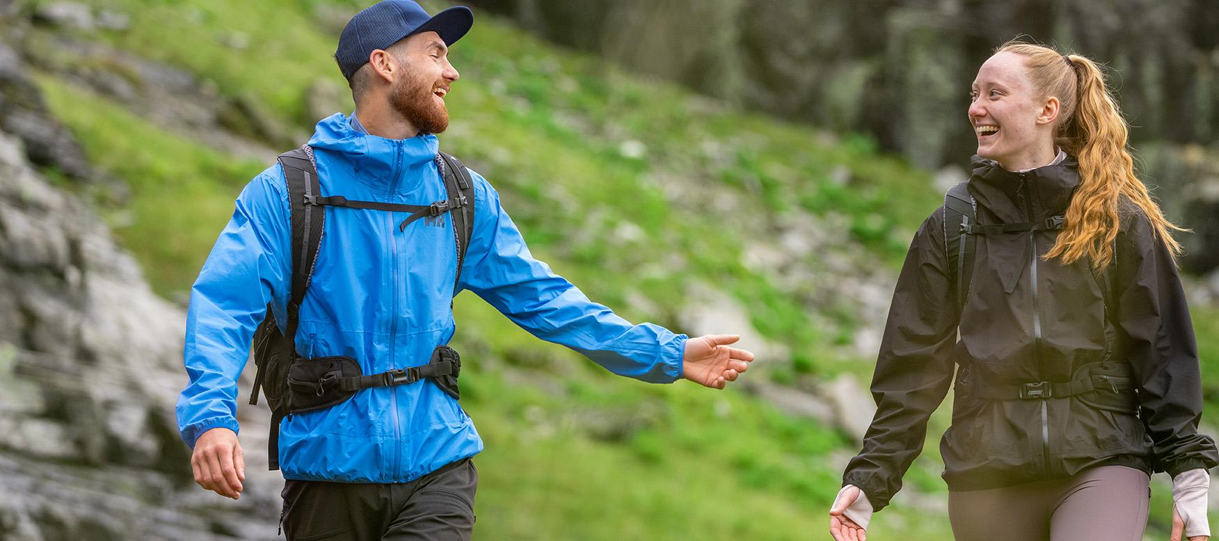 Man and woman laughing on a hike