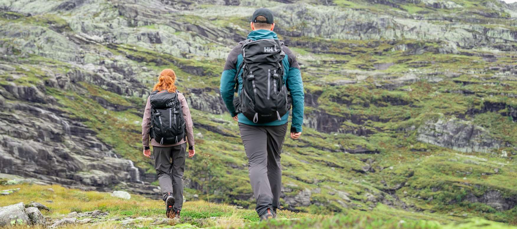 Man and woman hiking in the 45L Transistor backpacks.