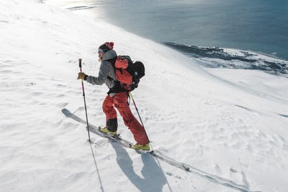 Woman hiking up powder snow ski touring