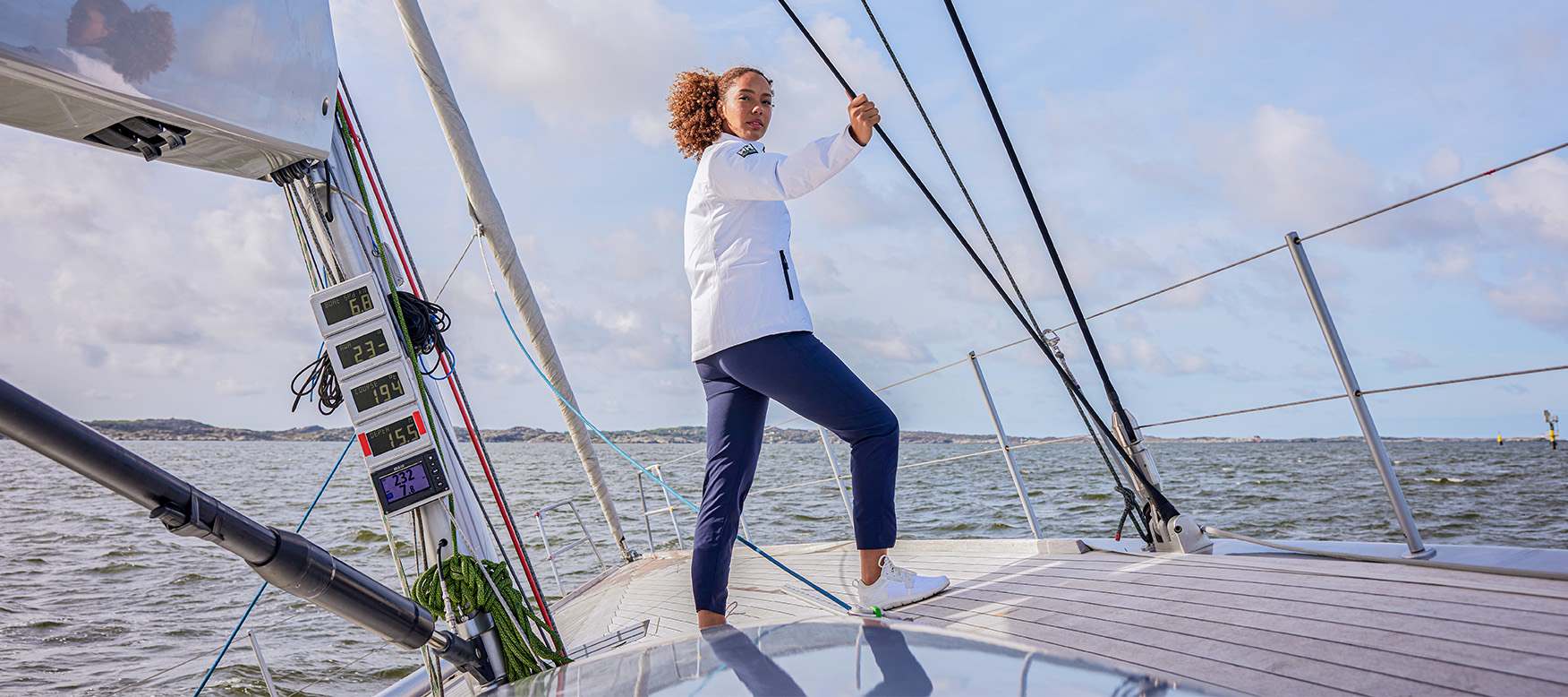 woman sailing in the Crew Midlayer 2.0 jacket