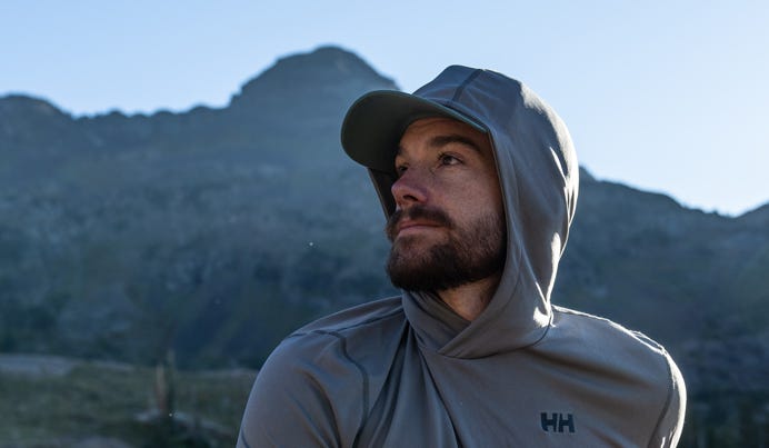 Male model wearing Helly Hansen sun protection hoodie