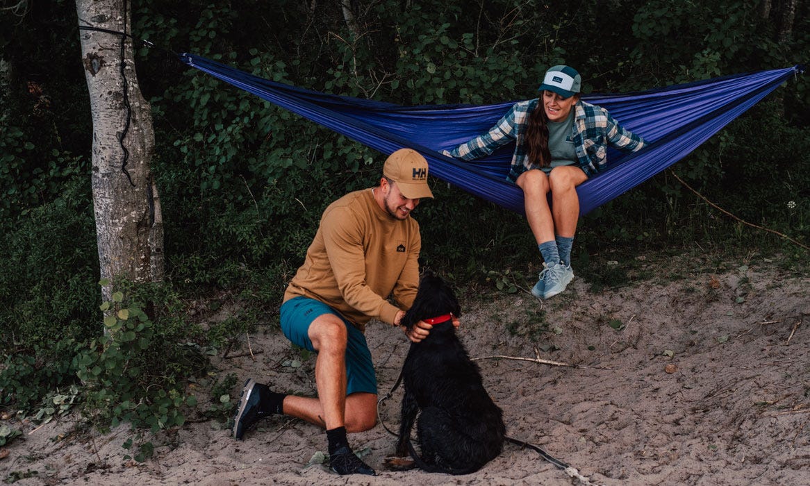 Male and female camping in Helly Hansen gear